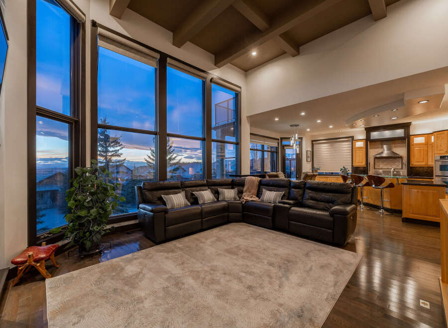 This stunning living room boasts expansive windows that frame breathtaking views.