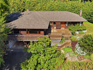 This stunning property boasts a beautiful wooden deck, perfect for enjoying the outdoors.