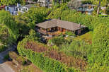 Nestled amidst lush greenery, this stunning property offers a serene retreat.
