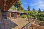 Enjoy the tranquility of this stunning property featuring a spacious wooden deck, perfect for outdoor entertaining and relaxation.