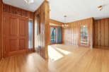 Step into this inviting home featuring beautiful wood paneling and hardwood floors throughout.