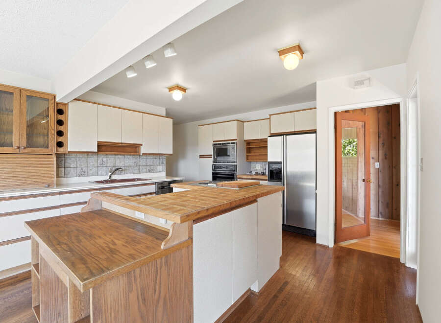 Step into this inviting kitchen, featuring a spacious layout and ample counter space.