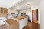 Step into this inviting kitchen, featuring a spacious layout and ample counter space.