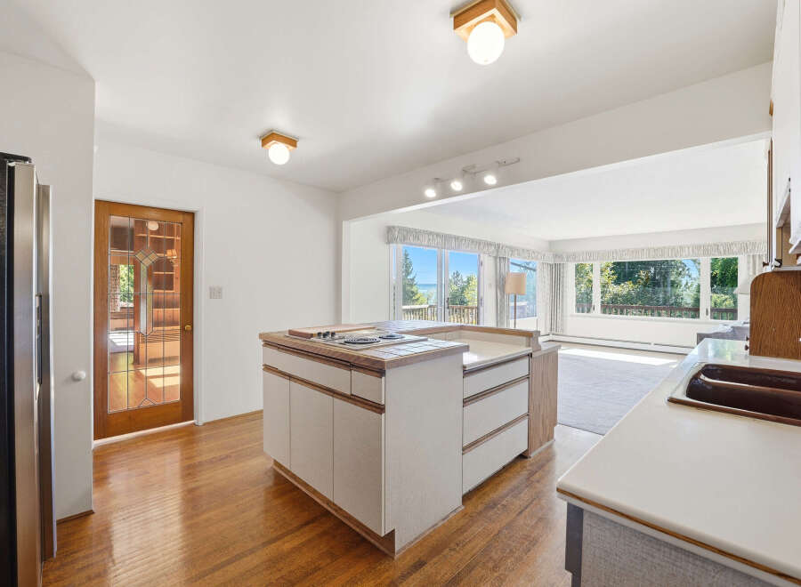 Step into this inviting kitchen, featuring a stylish island with a cooktop and ample storage.
