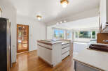 Step into this inviting kitchen, featuring a stylish island with a cooktop and ample storage.