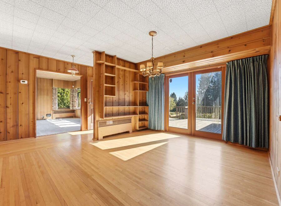 Step into this inviting space, featuring warm wood paneling and a bright, open layout.