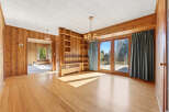 Step into this inviting space, featuring warm wood paneling and a bright, open layout.