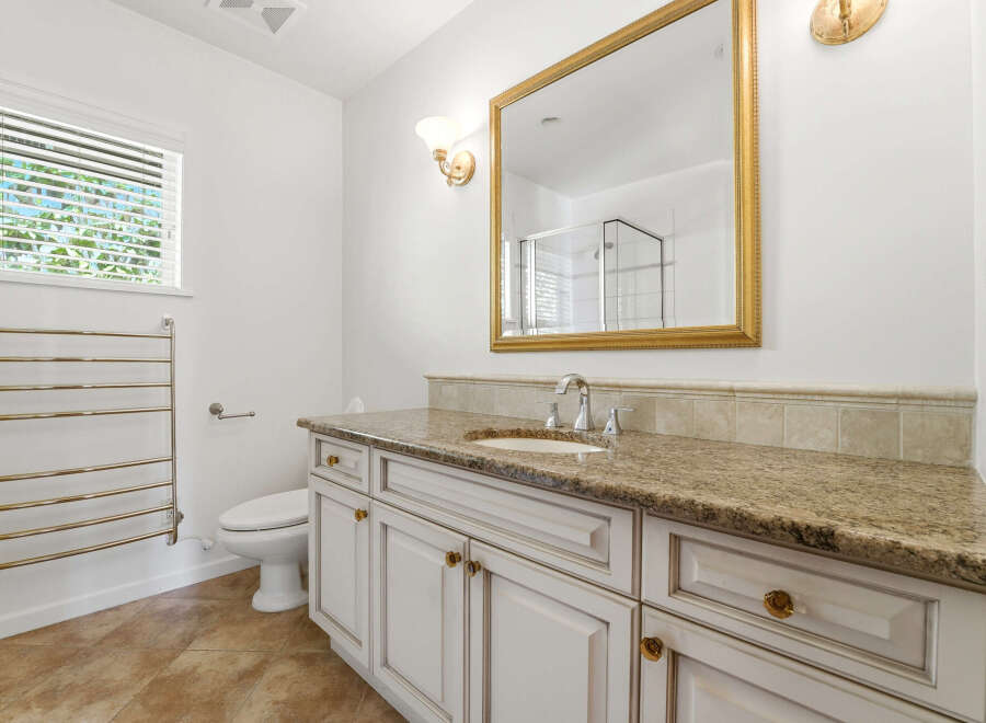 Step into luxury with this stunning bathroom! Featuring a beautiful vanity with a granite countertop, this space exudes elegance.