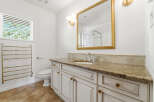 Step into luxury with this stunning bathroom! Featuring a beautiful vanity with a granite countertop, this space exudes elegance.