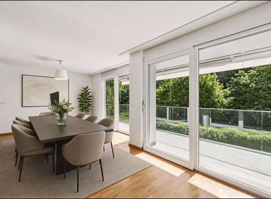 Experience luxury living in this stunning dining room, featuring a modern design and ample natural light.