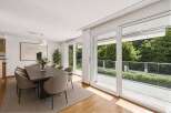 Experience luxury living in this stunning dining room, featuring a modern design and ample natural light.