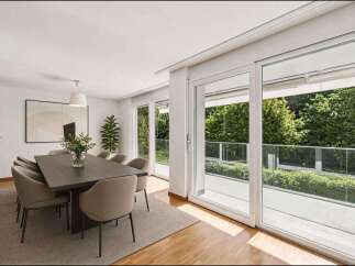 Experience luxury living in this stunning dining room, featuring a modern design and ample natural light.