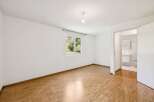 This bright and airy room features beautiful hardwood floors and a fresh, neutral color palette.