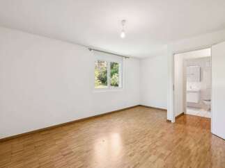 This bright and airy room features beautiful hardwood floors and a fresh, neutral color palette.