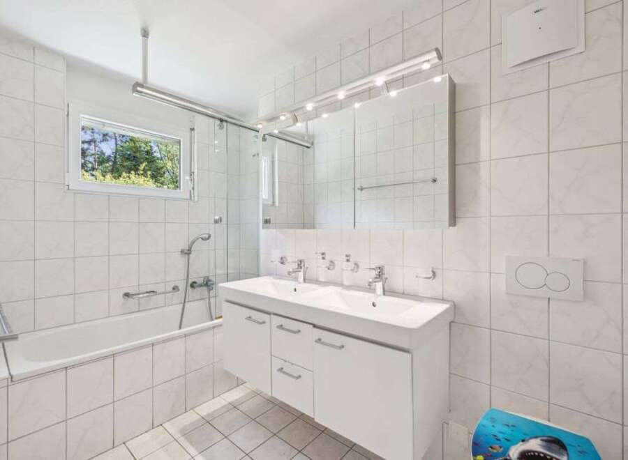 This bright and airy bathroom features a modern design with clean lines and a neutral color palette.