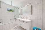 This bright and airy bathroom features a modern design with clean lines and a neutral color palette.
