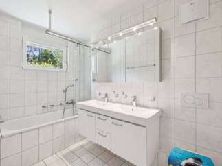 This bright and airy bathroom features a modern design with clean lines and a neutral color palette.