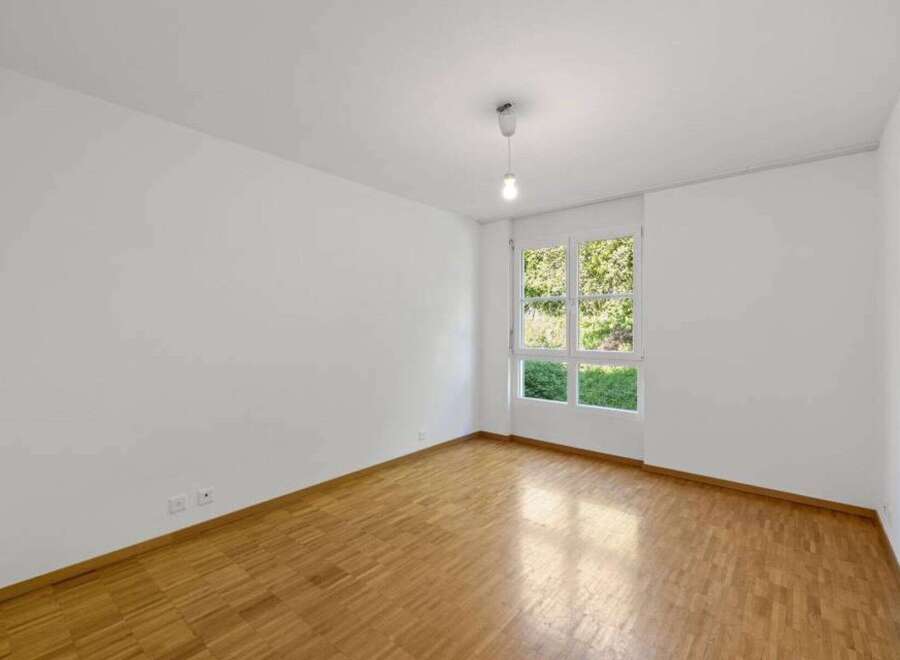 This bright and airy room features beautiful hardwood floors and crisp white walls, creating a clean and inviting atmosphere.