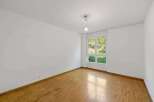 This bright and airy room features beautiful hardwood floors and crisp white walls, creating a clean and inviting atmosphere.