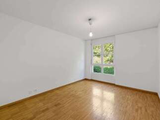 This bright and airy room features beautiful hardwood floors and crisp white walls, creating a clean and inviting atmosphere.
