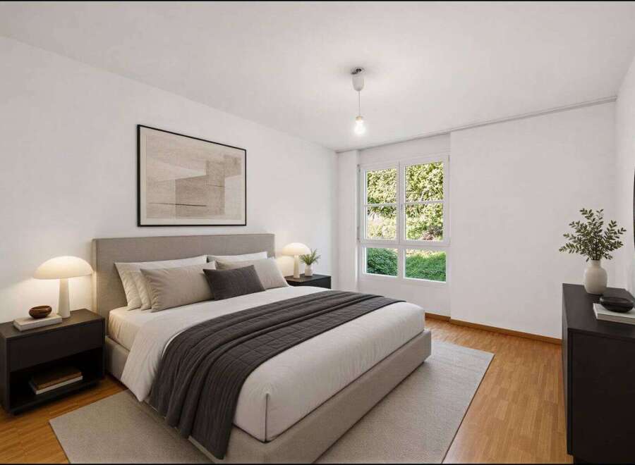 Step into this inviting bedroom, featuring a comfortable bed with a stylish gray throw and a neutral color palette.