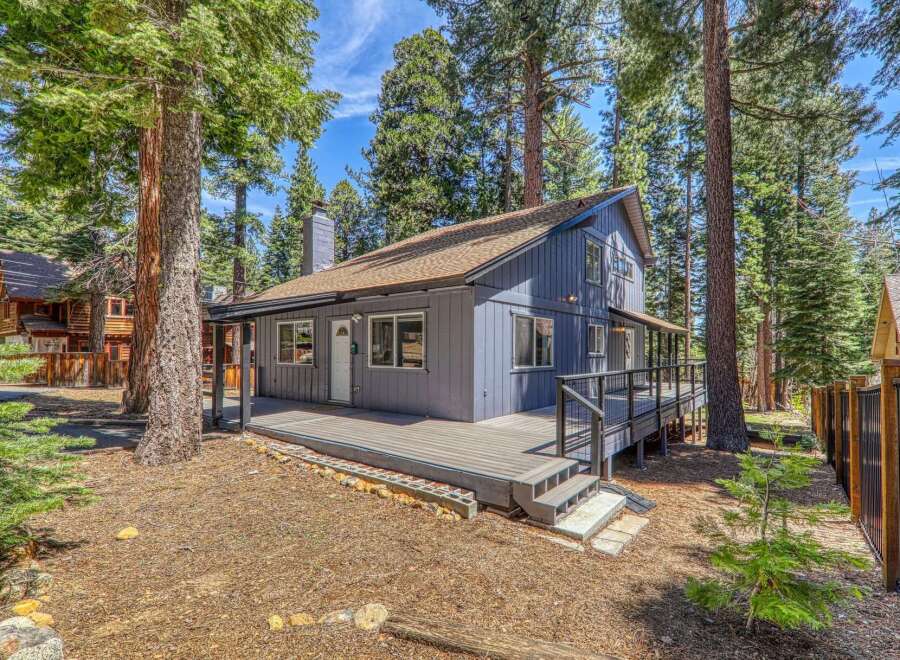 Nestled amidst towering trees, this charming home offers a serene escape.