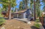 Nestled amidst towering trees, this charming home offers a serene escape.