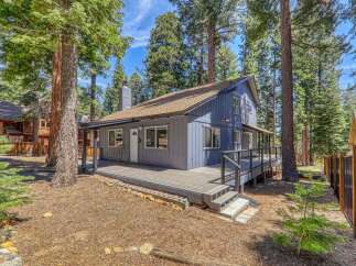 Nestled amidst towering trees, this charming home offers a serene escape.