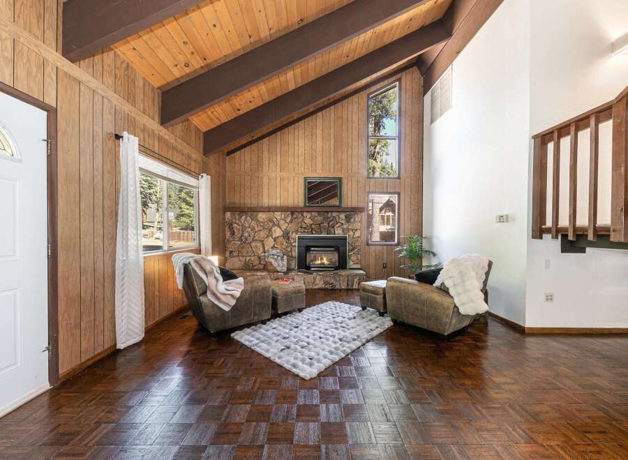 Step into this inviting living space, featuring a cozy fireplace and a plush rug, perfect for relaxing evenings.