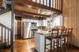Step into this charming kitchen, featuring a stylish island with seating, perfect for casual dining and entertaining.