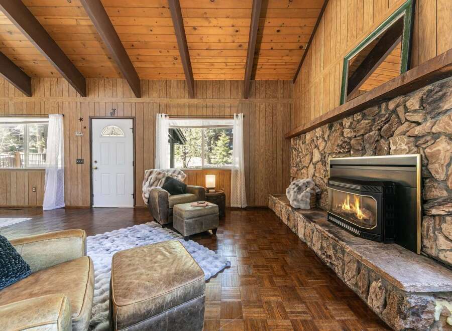 Step into a cozy living space with a stunning stone fireplace, perfect for those chilly evenings.