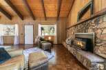 Step into a cozy living space with a stunning stone fireplace, perfect for those chilly evenings.