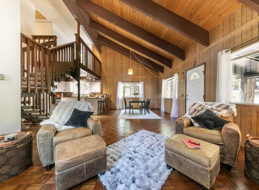 Step into this stunning property featuring a cozy living area with comfortable seating and a plush rug.