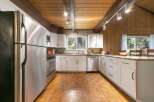 This stunning kitchen boasts a modern design with stainless steel appliances and ample counter space, perfect for culinary enthusiasts.
