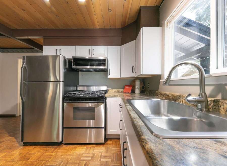 Step into this inviting kitchen, featuring stainless steel appliances and ample counter space.