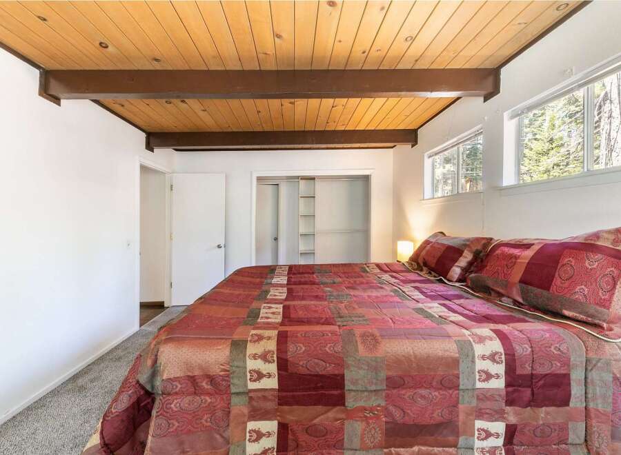 Step into this inviting bedroom, featuring a cozy bed adorned with a beautiful quilt.