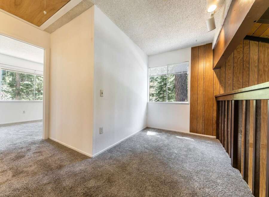 Step into this inviting space, featuring a neutral color palette and plush carpeting.
