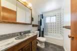 This charming bathroom features a classic design with a wooden vanity and a stylish countertop.