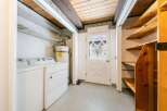 Step into this charming laundry room, complete with a washer and dryer, and a water heater.