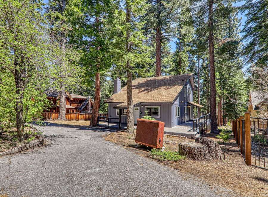Nestled amidst towering trees, this charming cabin offers a serene escape.