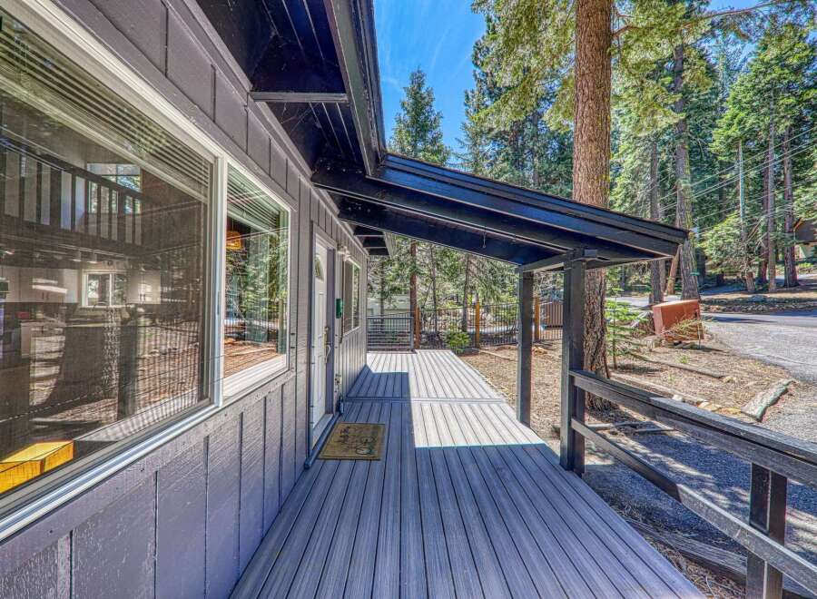 This charming property boasts a welcoming covered porch, perfect for enjoying the serene surroundings.
