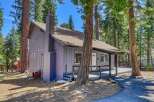 Nestled amidst towering trees, this charming cabin offers a serene escape.