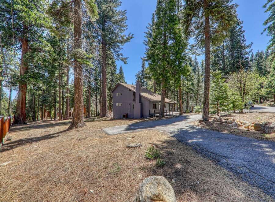 Nestled amidst towering trees, this charming property offers a serene escape.