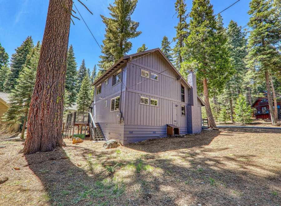 Nestled amidst towering trees, this charming property offers a serene escape.