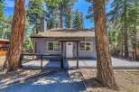 Nestled in a serene, wooded setting, this charming home offers a tranquil escape.