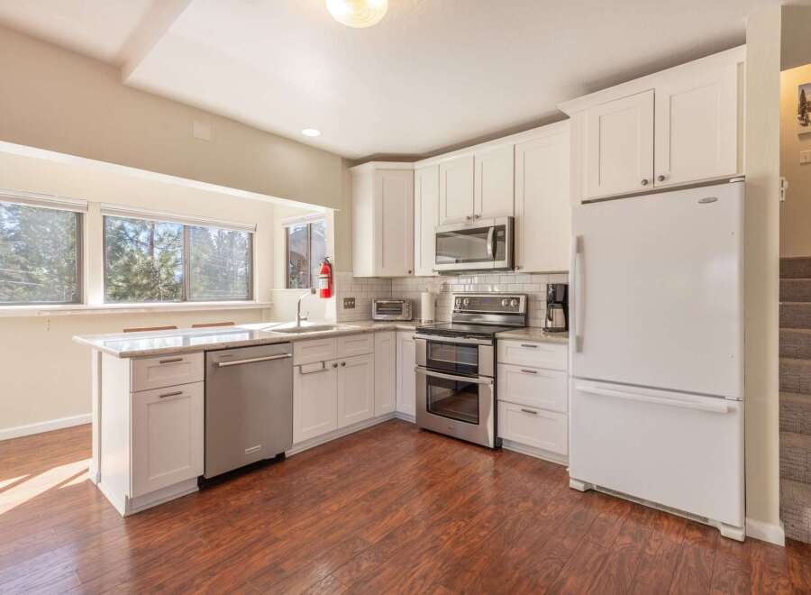 This stunning kitchen boasts modern appliances and ample counter space, perfect for culinary enthusiasts.