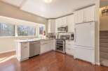 This stunning kitchen boasts modern appliances and ample counter space, perfect for culinary enthusiasts.