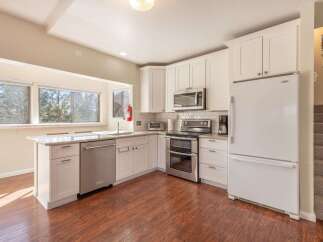 This stunning kitchen boasts modern appliances and ample counter space, perfect for culinary enthusiasts.