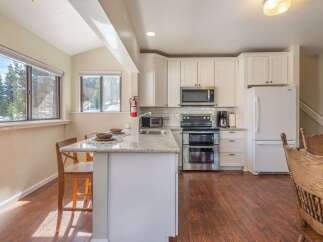 This stunning kitchen boasts modern appliances and a bright, airy design, perfect for culinary enthusiasts.