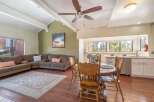 This stunning property boasts a spacious living area with a cozy sectional sofa and a beautiful rug, perfect for relaxing or entertaining.